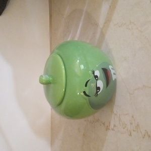 A M&M green canister. It can hold a variety of things. Cookies, Candy, Keys.
